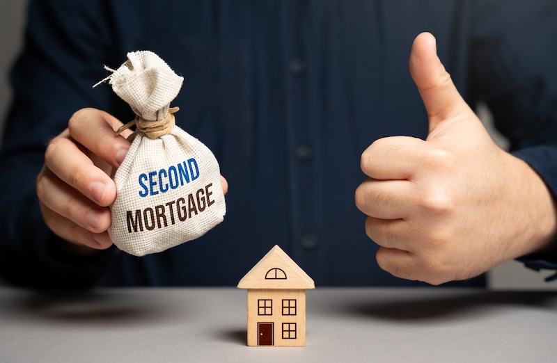The man approves of taking out a second mortgage. Buying a house. Financial strategy, home equity, and refinancing. Credit management.