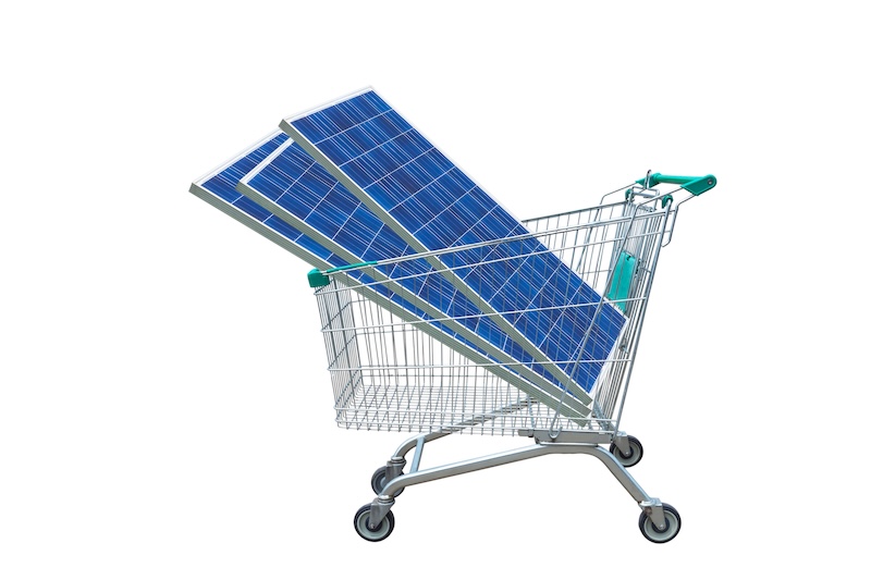 Photovoltaics solar panels module in shopping trolley cart isolated on white background.