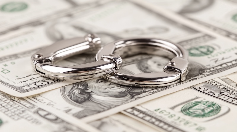 Silver handcuffs rest firmly on a stack of crisp dollar bills, creating a striking contrast against a clean white background, evoking thoughts of economic constraints and control. SSUCv3H4sIAAAAAAAACpxSQW7DIBC8V+ofLM6xZAO2434l6mExJEYlYAFOFUX5ewGblF57887Ozu4wfry/VRVi4OSEPqpHrEItlVqdt+Cl0QFuDjtuhebClsjNkr4pAZChanMluPTGSlAlhYGfZg1XEUC9KhXhZ2oi58GvTrjilhYTe46aBW0CLy5B9w8xmzhtdZUbqRkmQguhQ4G5lSUsQ5v4vya3j8/XI1yEnu7xtmdxtRVKwGbutFHR17cX9ppc7CRYuTSFq5uZQEUCKZRALmBhm9t5V8NFfOW2L3iLlZPUl0Le+DkFmMcms2pv76VDpIxZgKkYzznsFhmfwblA5xkvAwm/i7kWe7TxyeiuinhILJYtoU0/jrgnLek73NF2J2zJzzLopHPygeuiDHARl75SQcANE4E5fUXHA8FkoF0zviL6/WlCj3YUN+PWKuNI85KXjy/jGgQDYedjh+sO2rGm7MjqIwy85n3PKe4w9EBD9M8fAAAA//8DAHRrxjA8AwAA